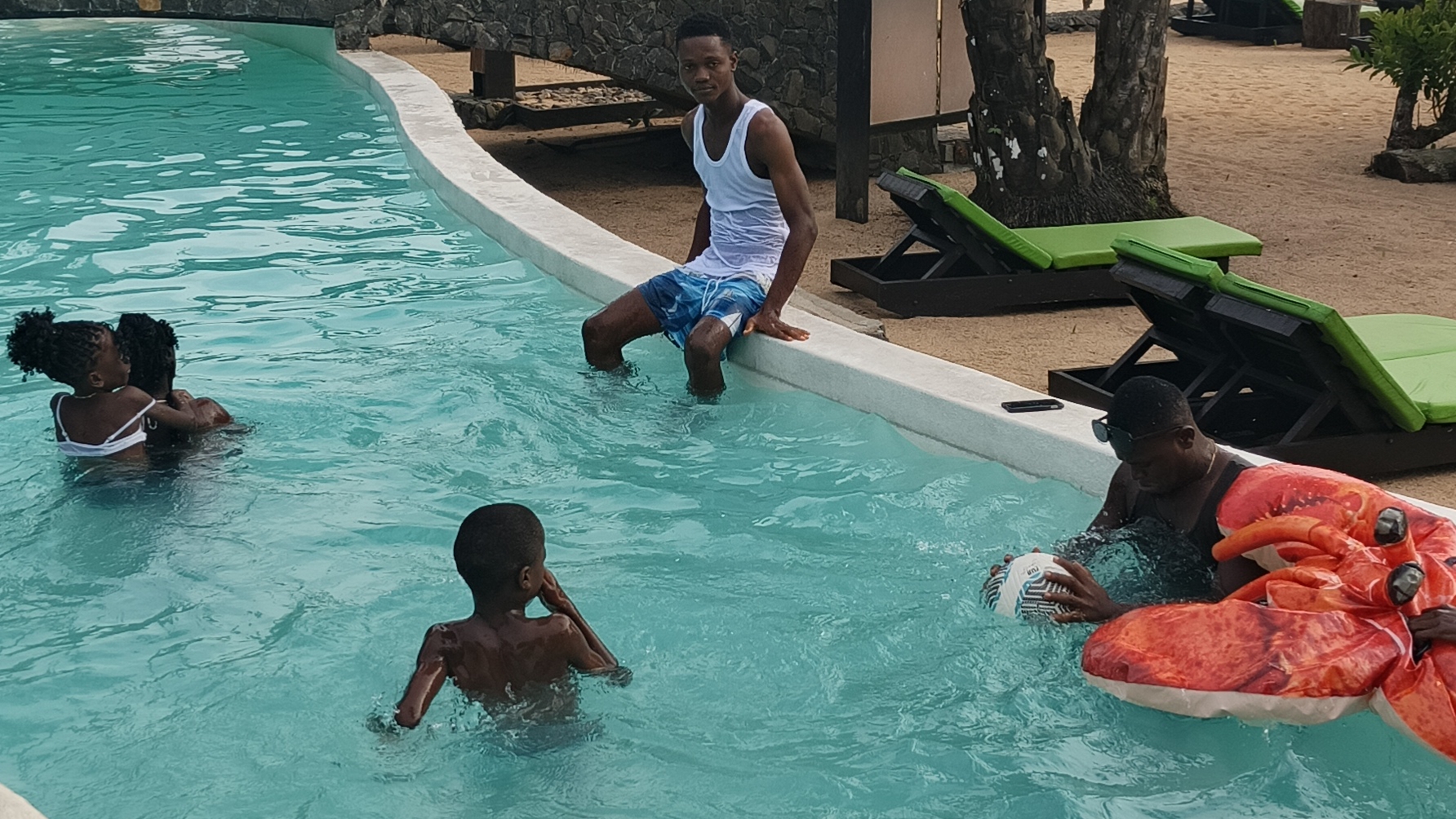 Nathan R. Watalah enjoying poolside time with friends in Maryland County, Liberia during semester break 2025